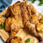 Pinterest Pin with text 'How to Spatchcock & Grilled a Whole Chicken', image of golden brown grilled chicken on a cutting board.