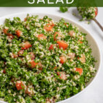 Pinterest Pin with text 'Tabbouleh Salad', image of a large white bowl of tabbouleh salad with parsley, bulgur, and tomatoes.