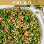 Pinterest Pin with text 'Homemade Tabbouleh Salad', image of a large white bowl of tabbouleh salad with parsley, bulgur, and tomatoes.