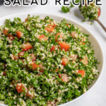 Pinterest Pin with text 'Tabbouleh Salad', image of a large white bowl of tabbouleh salad with parsley, bulgur, and tomatoes.