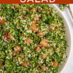 Pinterest Pin with text 'Tabbouleh Salad', image of a large white bowl of tabbouleh salad with parsley, bulgur, and tomatoes.