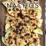 Pinterest pin with text 'Easy & Healthy Apple Nachos', image showing cutting board layered with apples and toppings.