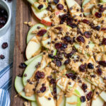 Pinterest pin with text 'Healthy Apple Nachos', image showing cutting board layered with apples and toppings.