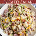 Pinterest Pin with text 'Healthier Bacon Ranch Potato Salad', image of a large white bowl holding bacon ranch potato salad.