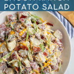 Pinterest Pin with text 'Healthier Bacon Ranch Potato Salad', image of a large white bowl holding bacon ranch potato salad.