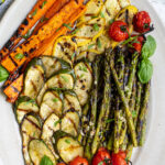 Pinterest pin with text 'Grilled & Marinated Vegetables', image of a platter filled with freshly grilled veggies laid out nicely on a platter.