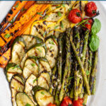 Pinterest pin with text 'Marinated Grilled Vegetables', image of a platter filled with freshly grilled veggies laid out nicely on a platter.