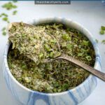 Pinterest Pin with text 'Homemade Ranch Seasoning Mix', image of a small bowl holding the ranch mix.