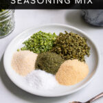 Pinterest Pin with text 'Homemade Ranch Seasoning Mix', image of a small white plate with piles of 6 different spices needed to make ranch.