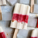 Pinterest Pin with text 'Healthy Parfait Breakfast Popsicles', image of a sheet tray filled with red and white layered popsicles.