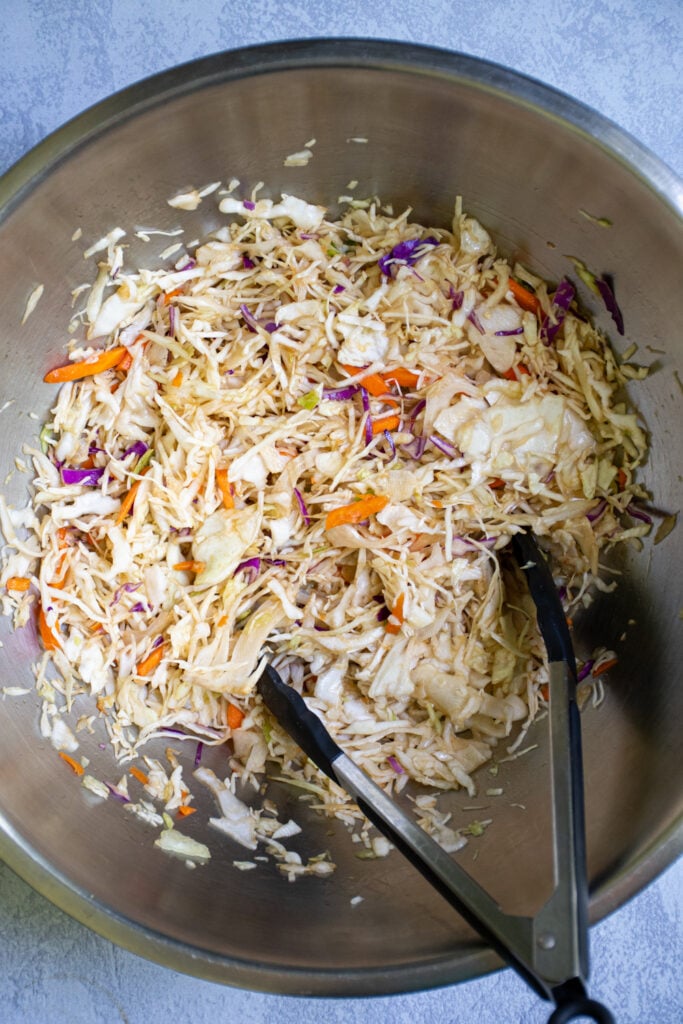A large bowl filled with asian coleslaw ready to be used for the tuna steak tacos.