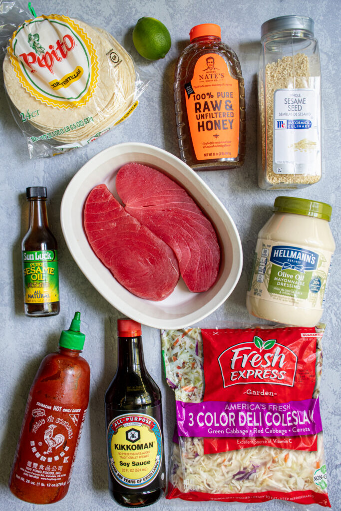 Ingredients needed to make tuna steak tacos laid out on a tabletop.