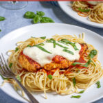 Pinterest Pin with text 'Baked Chicken Parmesan' image of a plate filled with spaghetti topped with a chicken parm.