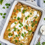 Pinterest Pin with text 'Green Chicken Enchiladas', image of white baking dish filled with green enchiladas.
