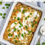 Pinterest Pin with text 'Green Chicken Enchiladas', image of white baking dish filled with green enchiladas.