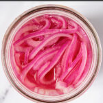 Pinterest Pin with text 'Quick Pickled Red Onions' with image of jar of red quick pickled onions.