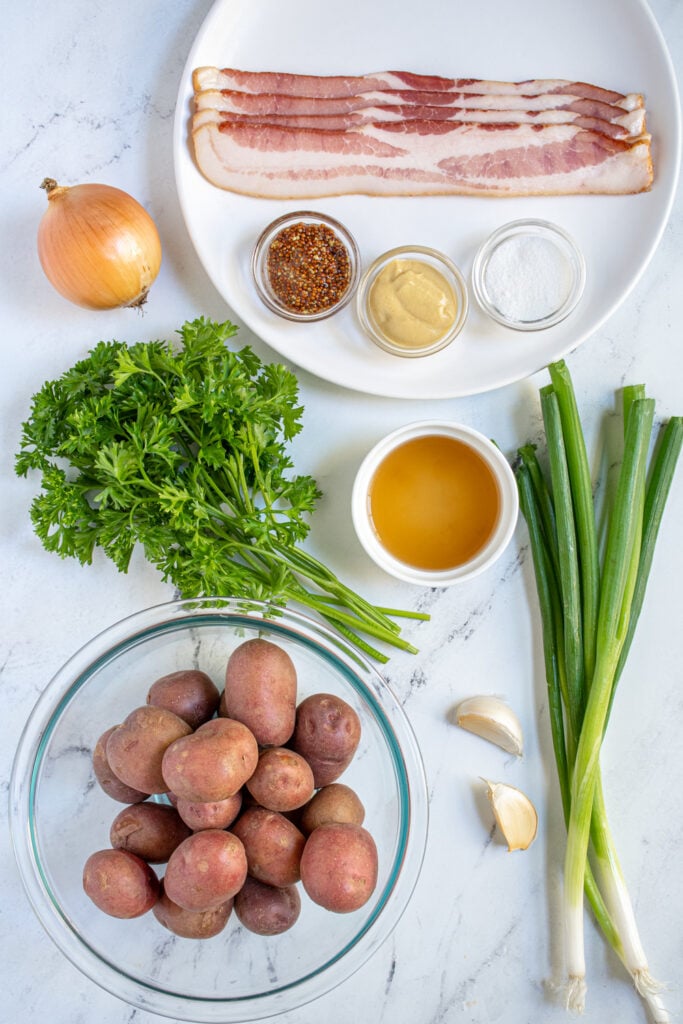 Ingredients from making homemade German potato salad laid out on a countertop.
