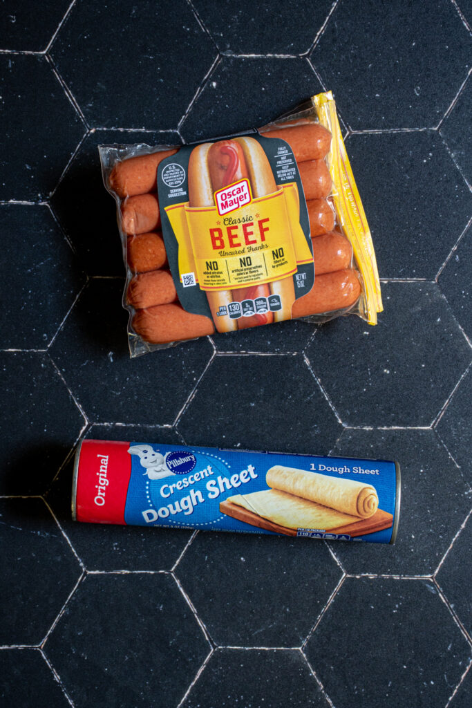 Ingredients for halloween mummy hot dogs include hot dogs and crescent dough.