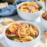 Pinterest Pin with text "Tortellini Soup with Chicken Sausage", image of a bowl of tortellini soup.