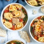 Pinterest Pin with text "Tortellini Soup with Chicken Sausage", image of bowls of tortellini soup.