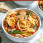 Pinterest Pin with text "Tortellini Soup with Chicken Sausage", image of a bowl of tortellini soup.