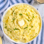 Pinterest Pin with text 'Mashed Potatoes Stovetop or Instant Pot Instructions', image of a large bowl of classic mashed potatoes with melted butter.