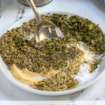 Pinterest Pin with text 'Homemade Italian Seasoning',image of a small plate with Italian seasoning ingredients.