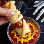 Pinterest Pin with text 'Halloween Mummy Dogs', image of mummy dogs with mustard eyes on a black plate.