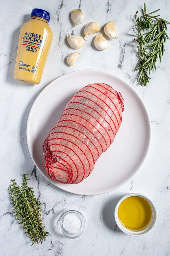 Ingredients for boneless leg of lamb roast laid out on a tabletop.