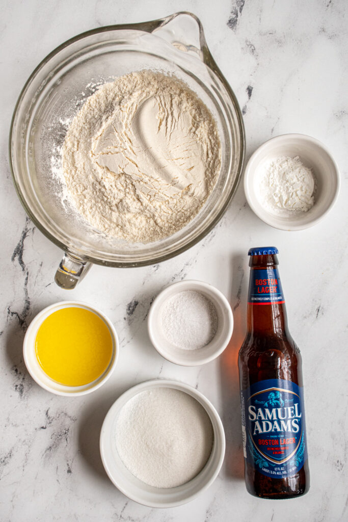 All the ingredients for easy beer bread including flour and a bottle of beer.