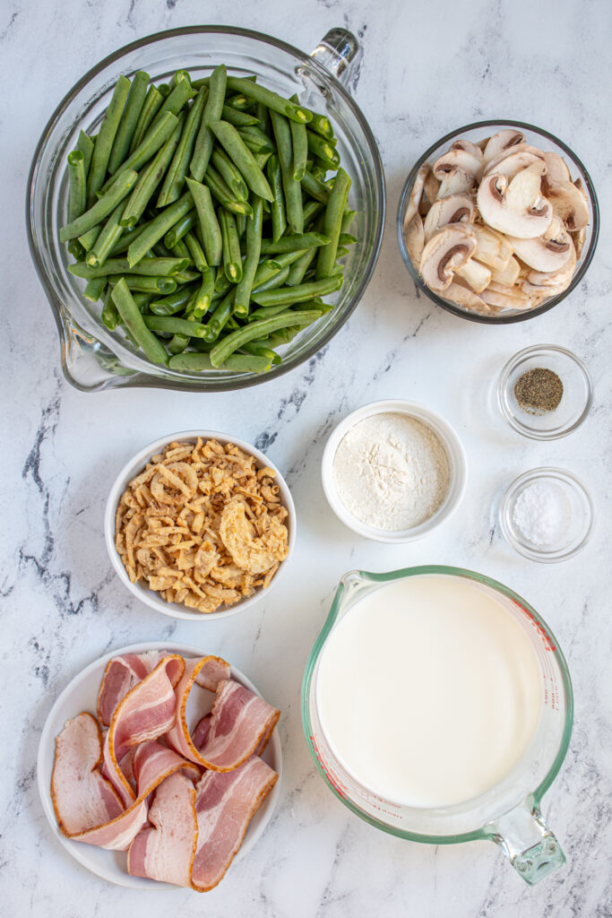 Ingredients needed for green bean casserole laid out on a tabletop.