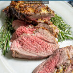Pinterest Pin with text 'Roasted Boneless Leg of Lamb', image of roasted lamb on a platter with slices showing off a pink tender center.