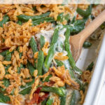 Pinterest Pin with text "Green Bean Casserole with Bacon", image of white casserole dish filled with fresh green bean casserole.