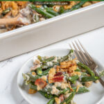 Pinterest Pin with text "Green Bean Casserole with Bacon", image of white casserole dish filled with fresh green bean casserole.