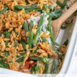 Pinterest Pin with text "Green Bean Casserole with Bacon", image of white casserole dish filled with fresh green bean casserole.