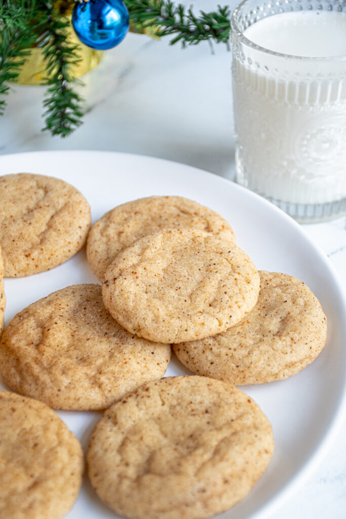 A close up of an eggnog snickerdoodle on a plate showing off the sugary cinnamon and nutmeg outside.