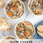 Pinterest Pin with text 'Crockpot Chicken Wild Rice Soup', image of white bowls filled with soup with spoons and bread.