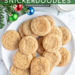 Pinterest Pin with text overlay 'Eggnog Snickerdoodles', image of a white plate full of snickerdoodles with a sugary cinnamon nutmeg outside.