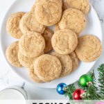 Pinterest Pin with text overlay 'Eggnog Snickerdoodles', image of a white plate full of snickerdoodles with a sugary cinnamon nutmeg outside.