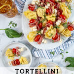 Pinterest Pin with text 'Tortellini Skewer', image of tortellini skewers of a white platter.