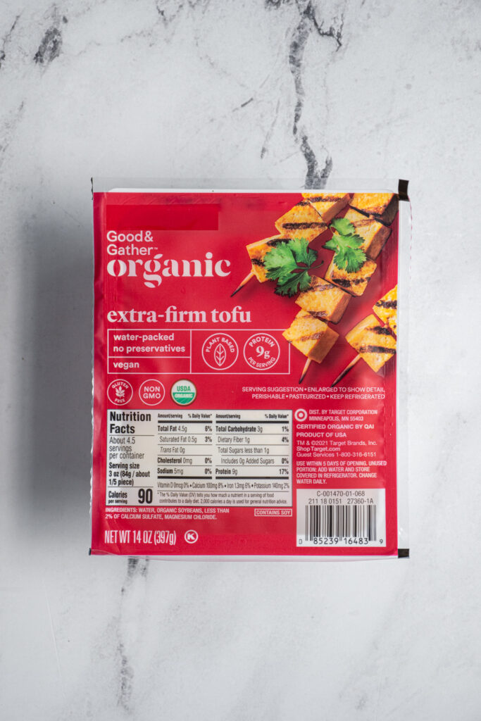 Package of extra firm tofu sitting a countertop.