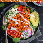 Pinterest Pin with text 'Buffalo Chickpea Salad', image of a brightly colored buffalo chickpea salad in a black bowl.