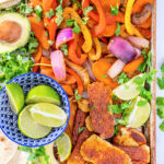 Pinterest Pin with text 'Quick & Easy Halloumi Fajitas', image with a tray full of fajita veggies and golden brown halloumi cheese.