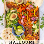 Pinterest Pin with text 'Halloumi Fajitas', image with a tray full of fajita veggies and golden brown halloumi cheese.