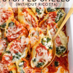 Pinterest pin with text 'Spinach Stuffed Shells without Ricotta', image of sauce and cheesy stuffed shells in a white casserole dish.