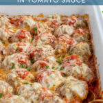 Pinterest Pin with text overlay 'Healthy Baked Turkey Meatballs Baked in Tomato Sauce', image of baked turkey meatballs covered in cheese in a casserole dish.