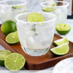 Pinterest Pin with text overlay 'How to make a Classic Margarita', image of a glass with a salted rim filled with a margarita and a lime wheel.