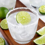 Pinterest Pin with text overlay 'How to make a Classic Margarita', image of a glass with a salted rim filled with a margarita and a lime wheel.