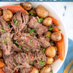 Pinterest Pin with text 'Crockpot Pot Roast', image of a serving bowl with chunks of pot roast, carrots, and baby potatoes.