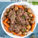 Pinterest Pin with text 'Crockpot Pot Roast', image of a serving bowl with chunks of pot roast, carrots, and baby potatoes.